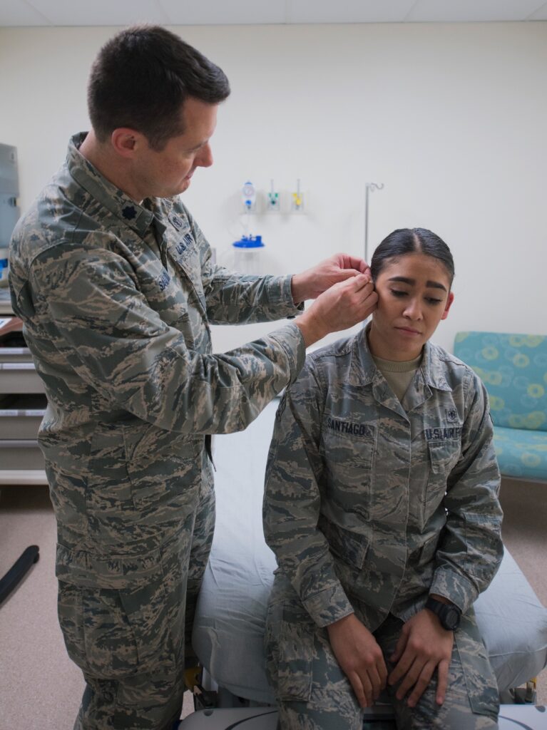 Military service member doing battlefield acupuncture