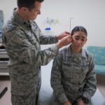 Military service member doing battlefield acupuncture