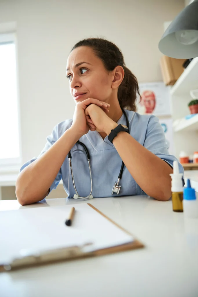 Nurse sitting at desk after trauma support with ear seeding